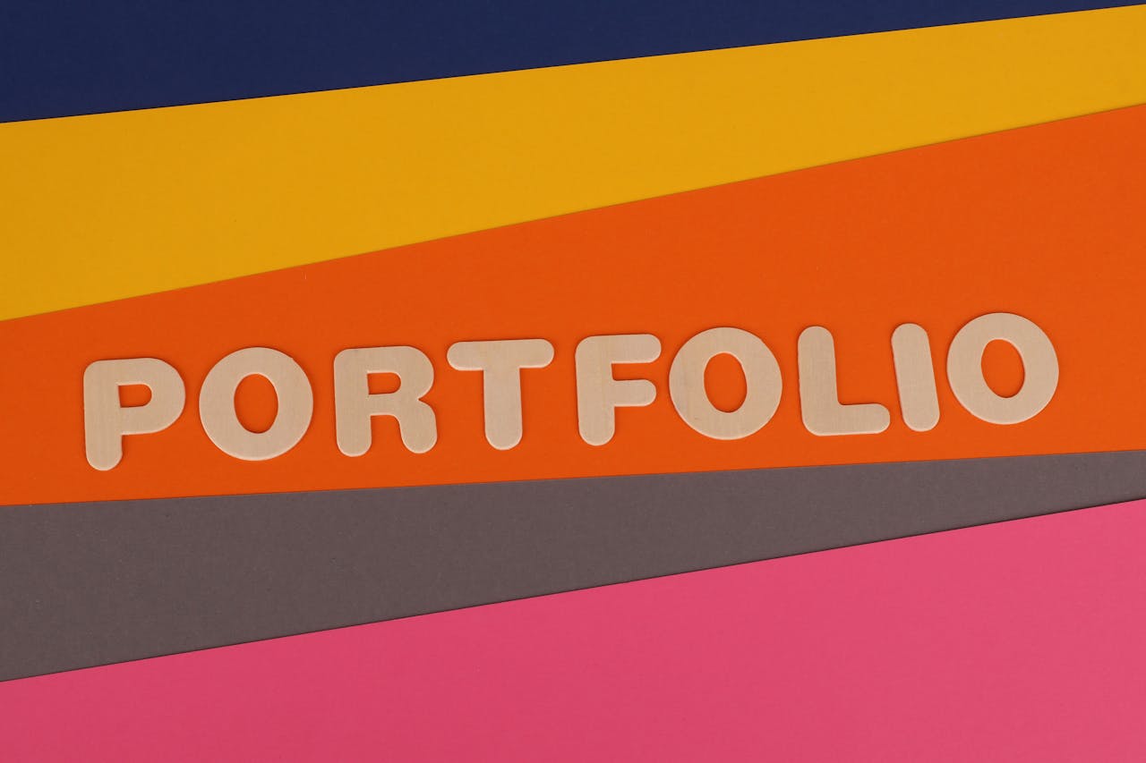 A vibrant multicolored background featuring the text PORTFOLIO in pink font on colorful paper.